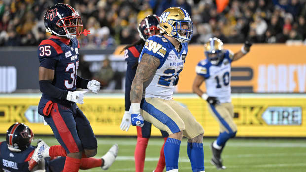 Nov 19, 2023; Hamilton, Ontario, CAN; Winnipeg Blue Bombers running back Brady Oliveira (20) celebrates after scoring a touchdown past Montreal Alouettes defensive back Reggie Stubblefield (35) in the first half at Tim Hortons Field. Mandatory Credit: Dan Hamilton-USA TODAY Sports