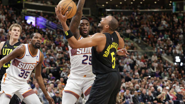 Nov 19, 2023; Salt Lake City, Utah, USA; Utah Jazz guard Talen Horton-Tucker (5) tries to shoot past Phoenix Suns forward Nassir Little (25) during the second half at Delta Center.