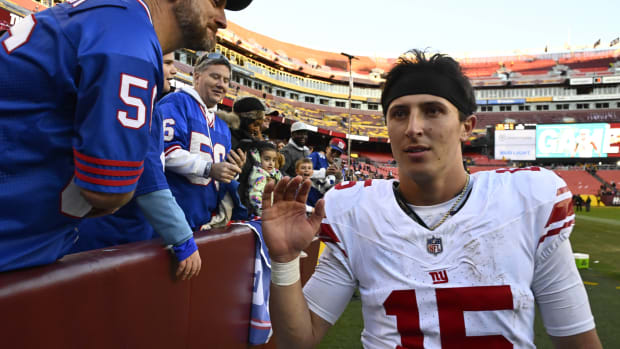 Nov 19, 2023; Landover, Maryland, USA; New York Giants quarterback Tommy DeVito (15) is congratulated by fans after the game against the Washington Commanders at FedExField.