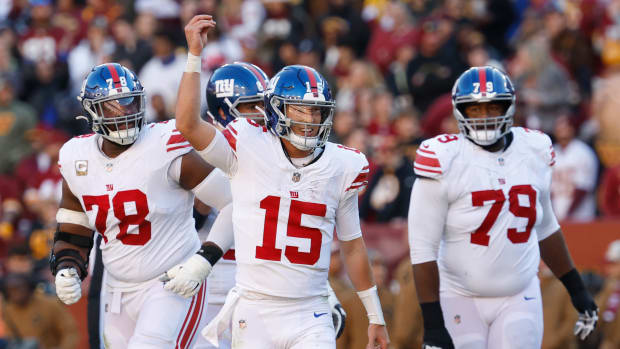 New York Giants quarterback Tommy DeVito celebrates after throwing a touchdown pass against the Washington Commanders during the second quarter at FedExField.