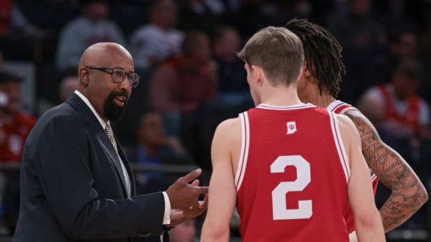 Indiana Hoosiers head coach Mike Woodson talks with guard Gabe Cupps (2) and guard CJ Gunn (11) during the first half against the Louisville Cardinals at Madison Square Garden. 