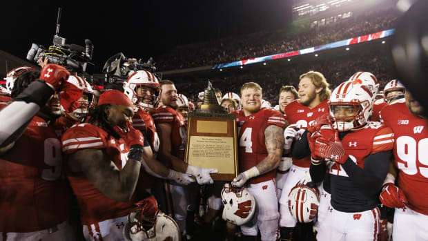 Nov 18, 2023; Madison, Wisconsin, USA; The Wisconsin Badgers celebrate with the Freedom Trophy following the game against the Nebraska Cornhuskers at Camp Randall Stadium. Mandatory Credit: Jeff Hanisch-USA TODAY Sports