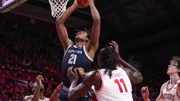 Nov 15, 2023; Piscataway, New Jersey, USA; Georgetown Hoyas center Ryan Mutombo (21) goes to the basket in front of Rutgers Scarlet Knights center Clifford Omoruyi (11) and guard Gavin Griffiths (10) during the first half at Jersey Mike's Arena.
