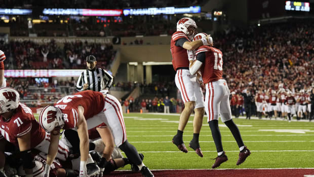 Dec 27, 2022; Phoenix, Arizona, USA; Wisconsin Badgers running back Braelon Allen (0) is hoisted by teammates as he celebrates a touchdown against the Oklahoma State Cowboys in the second half of the 2022 Guaranteed Rate Bowl at Chase Field. Mandatory Credit: Mark J. Rebilas-USA TODAY Sports