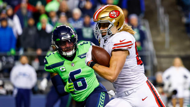 San Francisco 49ers tight end George Kittle (85) runs for a touchdown against Seattle Seahawks safety Quandre Diggs (6) after making a reception during the first quarter at Lumen Field.