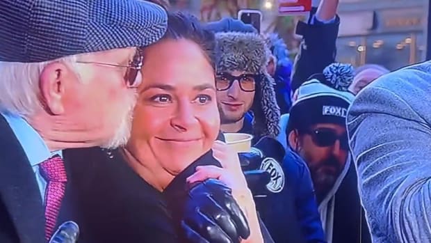 Fox Sports personality Terry Bradshaw kisses chef Antonia Lofaso during a broadcast on Nov. 23, 2023.