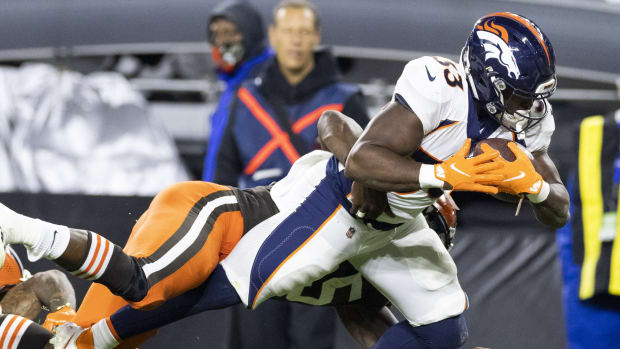 Denver Broncos running back Javonte Williams (33) scores a touchdown as he is tackled by the Cleveland Browns during the fourth quarter at FirstEnergy Stadium.