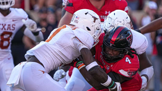 Texas Tech Red Raiders runningback SaRodorick Thompson (4) is tackled by Texas Longhorns players during a game at Jones AT&T Stadium. 