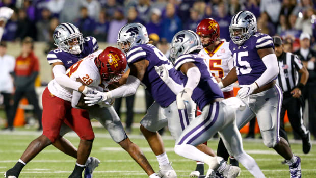 Oct 16, 2021; Manhattan, Kansas, USA; Iowa State Cyclones running back Breece Hall (28) is tackled by Kansas State Wildcats defensive back Julius Brents (23), defensive tackle Elliott Strahm (95) and defensive back Reggie Stubblefield (1) during the fourth quarter at Bill Snyder Family Football Stadium. Mandatory Credit: Scott Sewell-USA TODAY Sports  