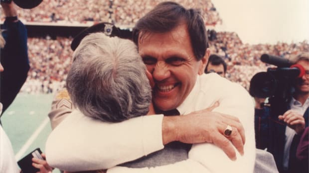 Former Texas A&M Aggies coach Jackie Sherrill hugs his then-defensive coordinator, R.C. Slocum at Kyle Field.