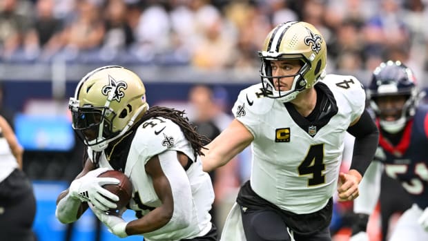 Saints quarterback Derek Carr hands the ball off to running back Alvin Kamara during New Orleans's 20-13 loss to the Texans on Oct. 15, 2023.