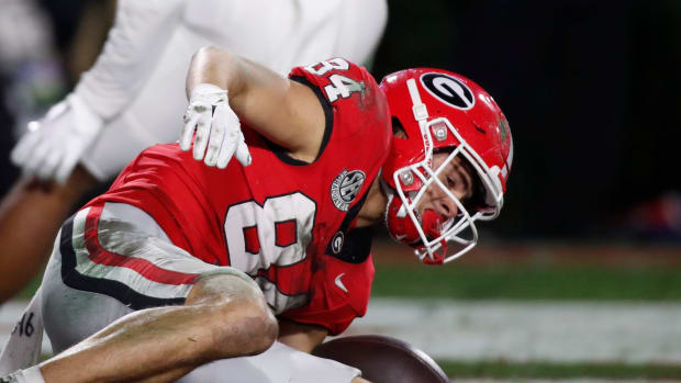 Georgia wide receiver Ladd McConkey (84) pulls in a pass from Georgia quarterback Carson Beck (15) for a touchdown during the first half of a NCAA college football game against Ole Miss in Athens, Ga., on Saturday, Nov. 11, 2023.  