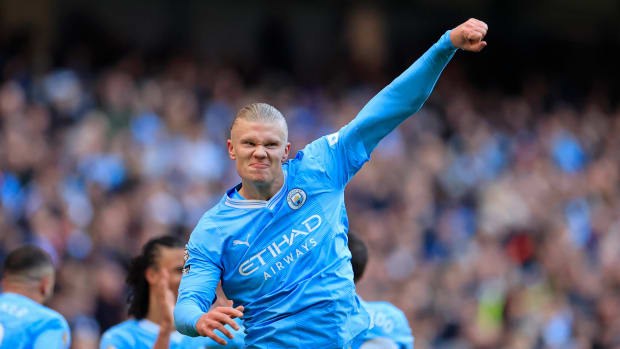 Erling Haaland pictured celebrating after scoring the 50th goal of his Premier League career during a game between Manchester City and Liverpool in November 2023