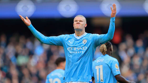 Manchester City forward Erling Haaland salutes the crowd after scoring his 50th goal in his 48th Premier League game, setting the all-time record.