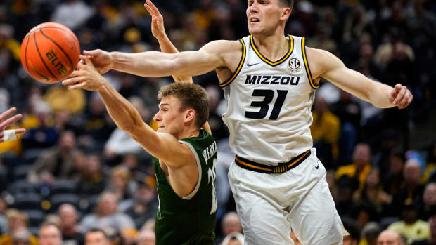 USA; Loyola (Md) Greyhounds guard Chris Kuzemka (20) and Missouri Tigers guard Caleb Grill (31) fight for a rebound during the second half at Mizzou Arena.