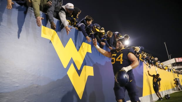 Nov 4, 2023; Morgantown, West Virginia, USA; West Virginia Mountaineers offensive lineman Zach Frazier (54) celebrates with fans after defeating the Brigham Young Cougars at Mountaineer Field at Milan Puskar Stadium.