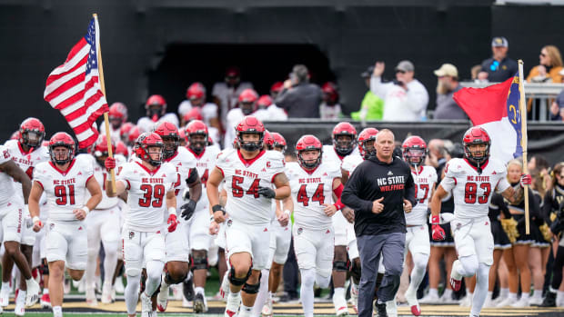 Nov 11, 2023; Winston-Salem, North Carolina, USA; North Carolina State Wolfpack head coach Dave Doeren leads his team onto the field during the first half against the Wake Forest Demon Deacons at Allegacy Federal Credit Union Stadium. Mandatory Credit: Jim Dedmon-USA TODAY Sports