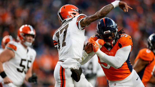 Cleveland Browns quarterback Dorian Thompson-Robinson (17) is hit by Denver Broncos linebacker Baron Browning (56) in the third quarter at Empower Field at Mile High.