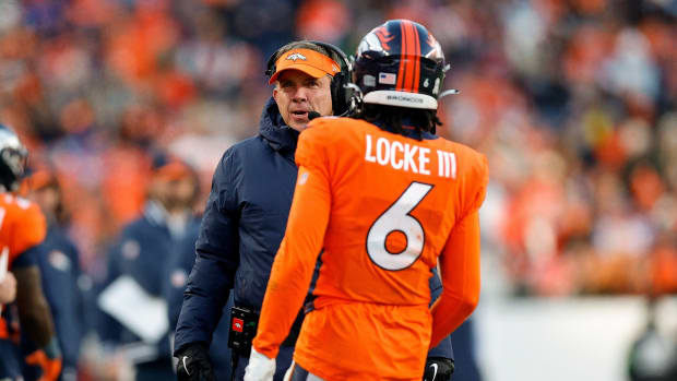 Denver Broncos head coach Sean Payton talks with safety P.J. Locke (6) in the third quarter against the Cleveland Browns at Empower Field at Mile High.