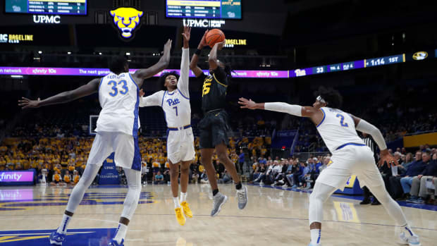 Nov 28, 2023; Pittsburgh, Pennsylvania, USA; Missouri Tigers guard Sean East II (55) shoots the all as Pittsburgh Panthers forward Zack Austin (55) and guard Carlton Carrington (7) and forward Blake Hinson (2) defend during the first half at the Petersen Events Center. 