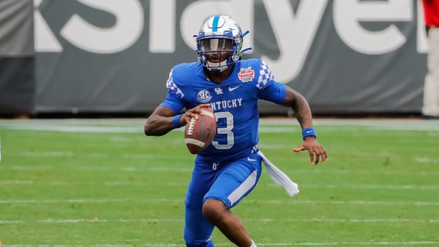 Jan 2, 2021; Jacksonville, FL, USA; Kentucky Wildcats quarterback Terry Wilson (3) carries the ball against the North Carolina State Wolfpack during the second half at TIAA Bank Field. Mandatory Credit: Mike Watters-USA TODAY Sports
