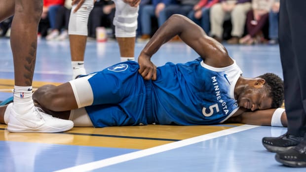 Nov 28, 2023; Minneapolis, Minnesota, USA; Minnesota Timberwolves guard Anthony Edwards (5) reacts after landing on the floor against the Oklahoma City Thunder in the second half at Target Center.