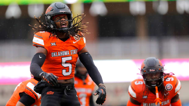 Oklahoma State's Kendal Daniels (5) celebrates an Oklahoma State fumble in the first half of the college football game between the Oklahoma State University Cowboys and the Brigham Young Cougars at Boone Pickens Stadium in Stillwater, Okla., Saturday, Nov. 25, 2023.