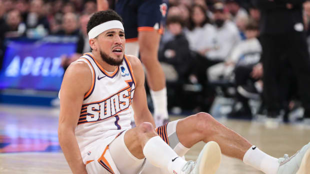 Phoenix Suns guard Devin Booker (1) reacts after being knocked down in the first quarter against the New York Knicks at Madison Square Garden.