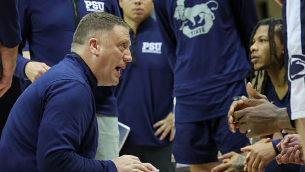 Penn State men's basketball coach Mike Rhoades talks with his team during a game against VCU.