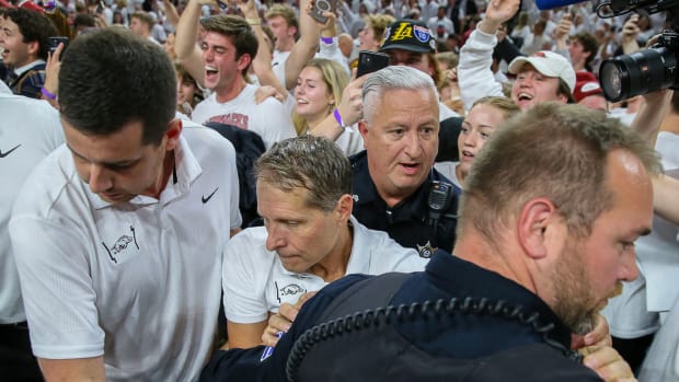 Razorbacks coach Eric Musselman as fans rush court after win over Duke