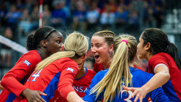 Kansas players celebrate a point against the Kansas State Wildcats in Horejsi Athletics Center