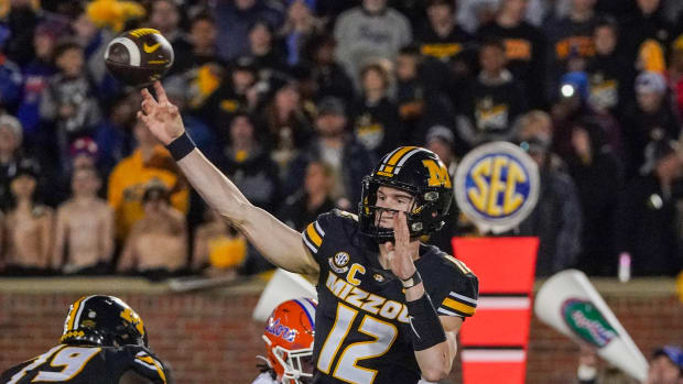 Nov 18, 2023; Columbia, Missouri, USA; Missouri Tigers quarterback Brady Cook (12) throws a pass against the Florida Gators during the first half at Faurot Field at Memorial Stadium. Mandatory Credit: Denny Medley-USA TODAY Sports  