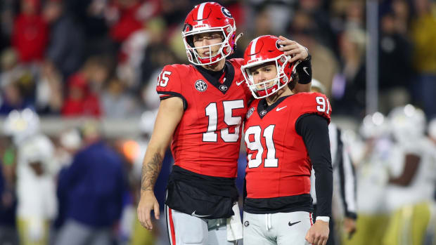 Georgia quarterback Carson Beck embraces kicker Peyton Woodring after a made extra point.