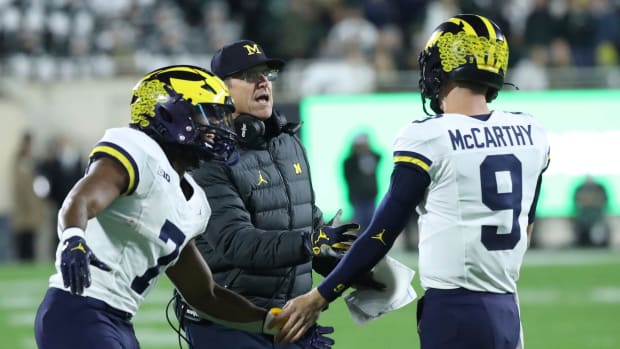 Michigan Wolverines head coach Jim Harbaugh, Donovan Edwards (7) J.J. McCarthy (9) celebrate after a touchdown against the Michigan State Spartans during first-half action at Spartan Stadium in East Lansing on Saturday, Oct. 21, 2023.
