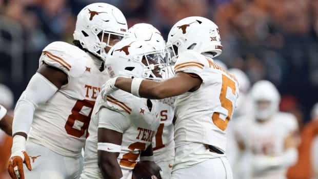 Texas's Kitan Crawford (21) celebrates an interception with Texas's Malik Muhammad (5) in the first half of the Big 12 Football Championship game between the Oklahoma State University Cowboys and the Texas Longhorns at the AT&T Stadium in Arlington, Texas, Saturday, Dec. 2, 2023.