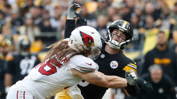 Arizona Cardinals linebacker Dennis Gardeck (45) hits Pittsburgh Steelers quarterback Kenny Pickett (8) as he releases the football during the first quarter at Acrisure Stadium.
