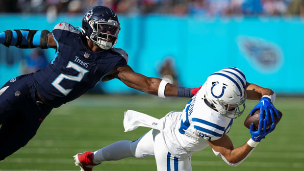 Indianapolis Colts tight end Kylen Granson (83) dives for a reception, under defensive pressure from Tennessee Titans linebacker Azeez Al-Shaair (2), on Sunday, Dec. 3, 2023, at Nissan Stadium in Nashville, Tenn.  