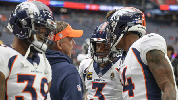 Denver Broncos head coach Sean Payton talks to Denver Broncos quarterback Russell Wilson (3) before playing against Houston Texans at NRG Stadium.