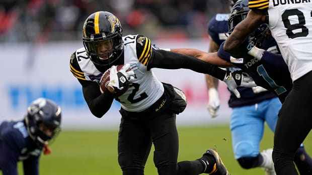 Dec 5, 2021; Toronto, Ontario, CAN; Hamilton Tiger-Cats wide receiver Tim White (12) gains yards after a pass reception against the Toronto Argonauts during the Canadian Football League Eastern Conference Final game at BMO Field. Hamilton defeated Toronto. Mandatory Credit: John E. Sokolowski-USA TODAY Sports