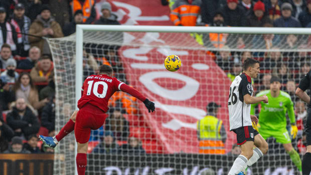 Alexis Mac Allister pictured (left) shooting to score the first goal of his Liverpool career during an EPL game against Fulham in December 2023