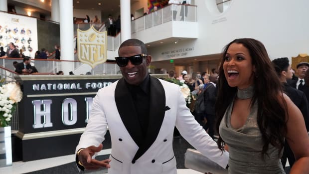 Deion Sanders (left) and Tracey Edmonds react during the NFL Honors awards presentation at Adrienne Arsht Center