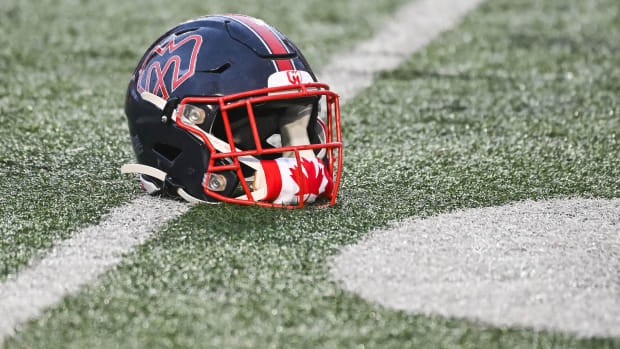 Jul 1, 2023; Montreal, Quebec, CAN; Montreal Alouettes helmet on the field with a Canadian flag covering the chin guard on Canada Day during warm-up before the game against the Winnipeg Blue Bombers at Percival Molson Memorial Stadium. Mandatory Credit: David Kirouac-USA TODAY Sports