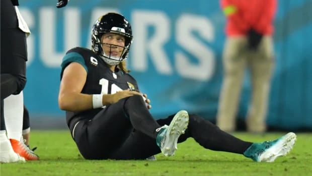 Jacksonville Jaguars quarterback Trevor Lawrence (16) looks up at a teammate after getting tackled by Cincinnati Bengals defensive end Sam Hubbard (94) late in the second quarter. The Jacksonville Jaguars hosted the Cincinnati Bengals at EverBank Stadium in Jacksonville, Florida for Monday Night Football, December 4, 2023. The Jaguars were tied 14 to 14 at the end of the first half. [Bob Self/Florida Times-Union]  