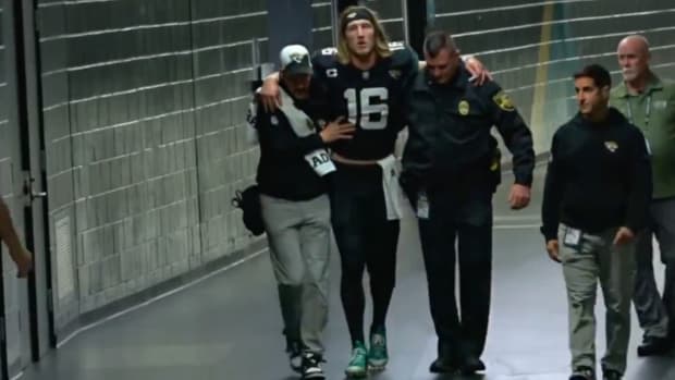Jacksonville Jaguars quarterback Trevor Lawrence is helped back to the locker room after suffering an injury in a Dec. 4, 2023 game.