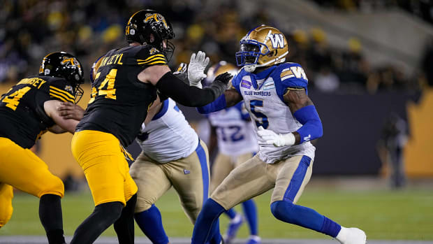 Dec 12, 2021; Hamilton, Ontario, CAN; Hamilton Tiger-Cats offensive lineman Chris Van Zeyl (54) blocks against Winnipeg Blue Bombers defensive lineman Willie Jefferson (5) during the first half for the 108th Grey Cup football game at Tim Hortons Field. Mandatory Credit: John E. Sokolowski-USA TODAY Sports