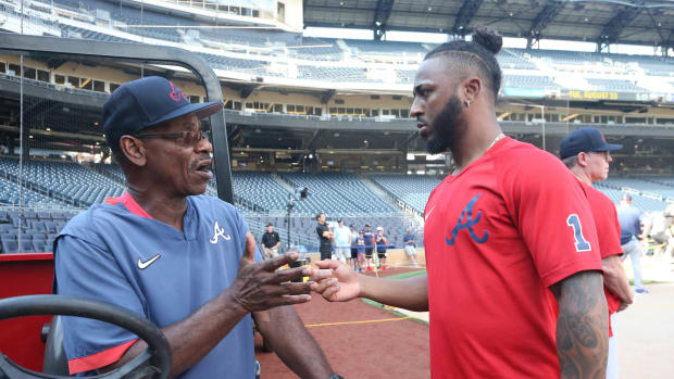 Aug 23, 2022; Pittsburgh, Pennsylvania, USA; Atlanta Braves third base coach Ron Washington (left) and shortstop Ozzie Albies (1) talk during batting practice before the game against the Pittsburgh Pirates at PNC Park.