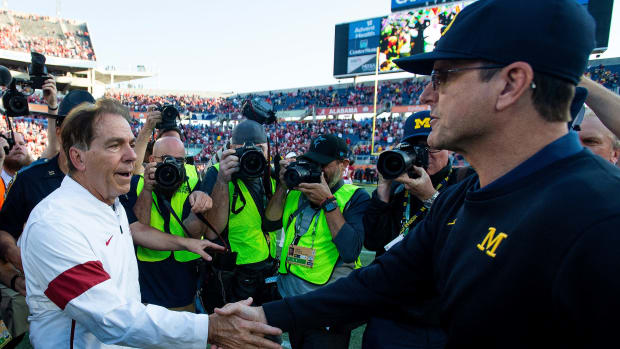 Alabama head coach Nick Saban greets Michigan head coach Jim Harbaugh at midfield after the Citrus Bowl in Orlando, Fla., on Wednesday January 1, 2020.