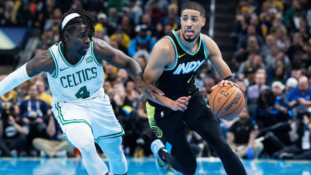 Indiana Pacers guard Tyrese Haliburton dribbles past Boston Celtics guard Jrue Holiday.