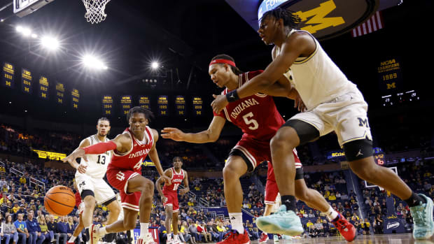 Hoosiers forward Anthony Walker (4) and Hoosiers forward Malik Reneau (5) go for the ball against the Michigan Wolverines.