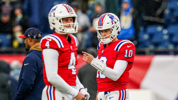 New England Patriots quarterback Mac Jones (10) and quarterback Bailey Zappe (4) in the field to warm up before the start of the game against the Los Angeles Chargers at Gillette Stadium.